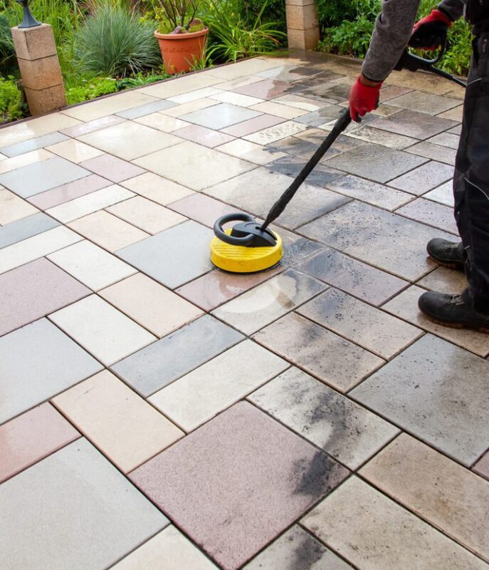 Person worker cleaning the outdoors floor.